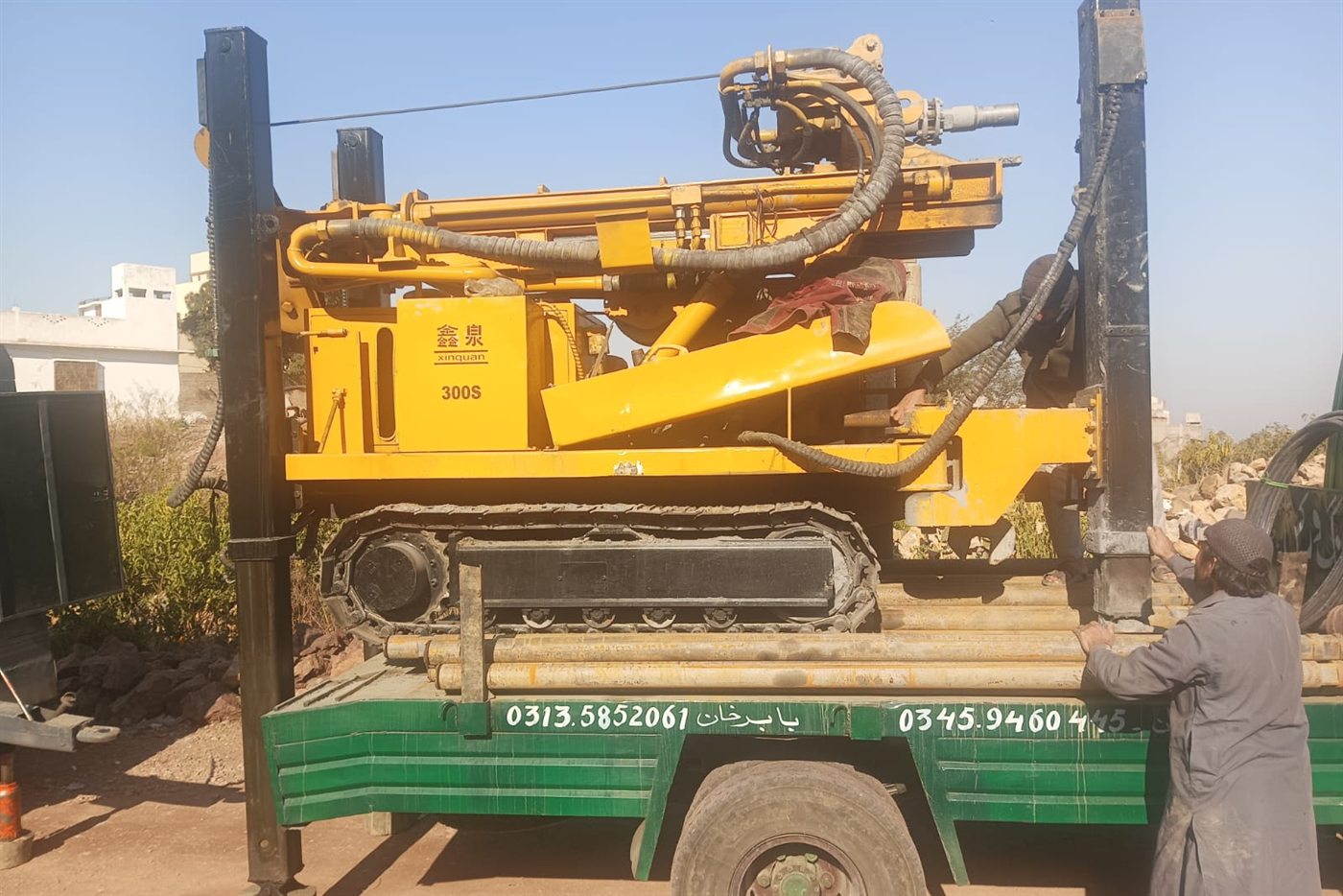 A truck-mounted drilling rig on site for a community water well