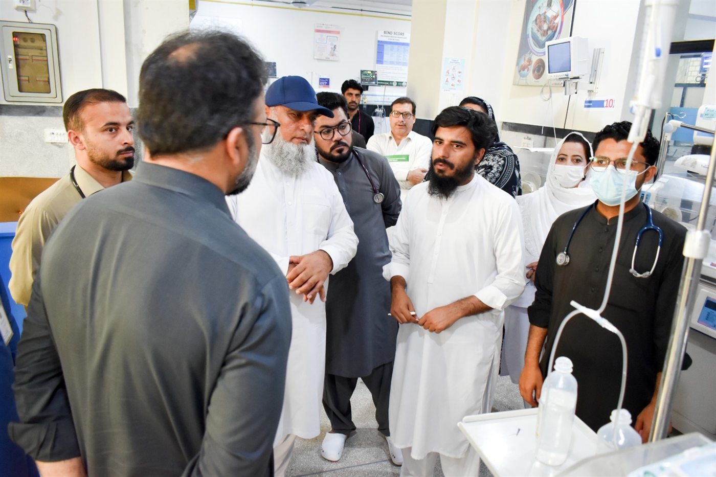 LEO representatives with doctors and nursing staff in a hospital neonatal unit, beside the ward's equipment