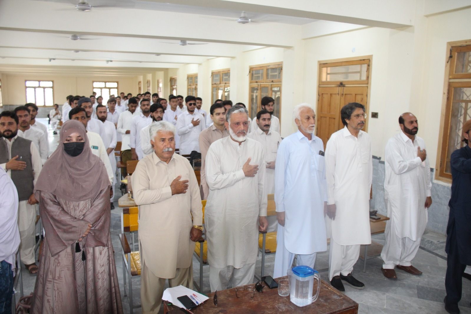 Students, staff and community members standing together at a LEO International Workers Day event at a government college in Khyber Pakhtunkhwa
